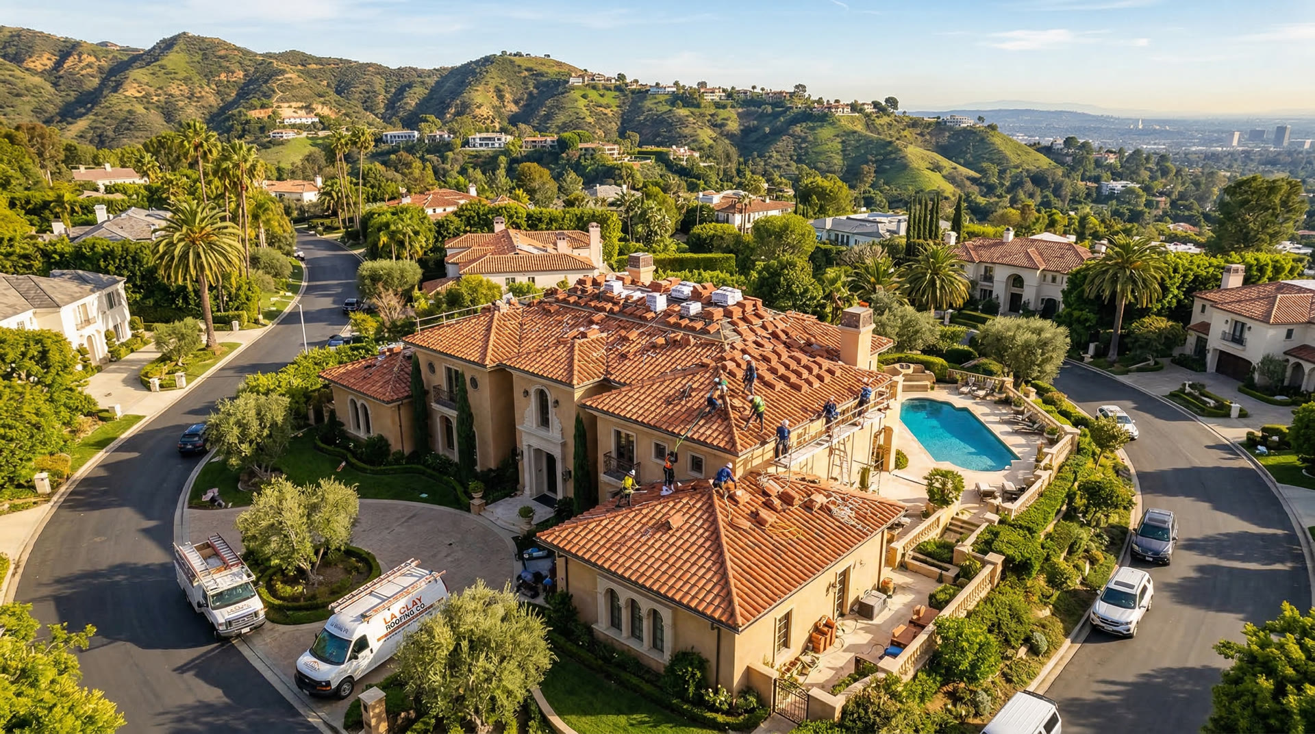 Aerial view of roof replacement on a luxury Los Angeles home with clay tile roofing