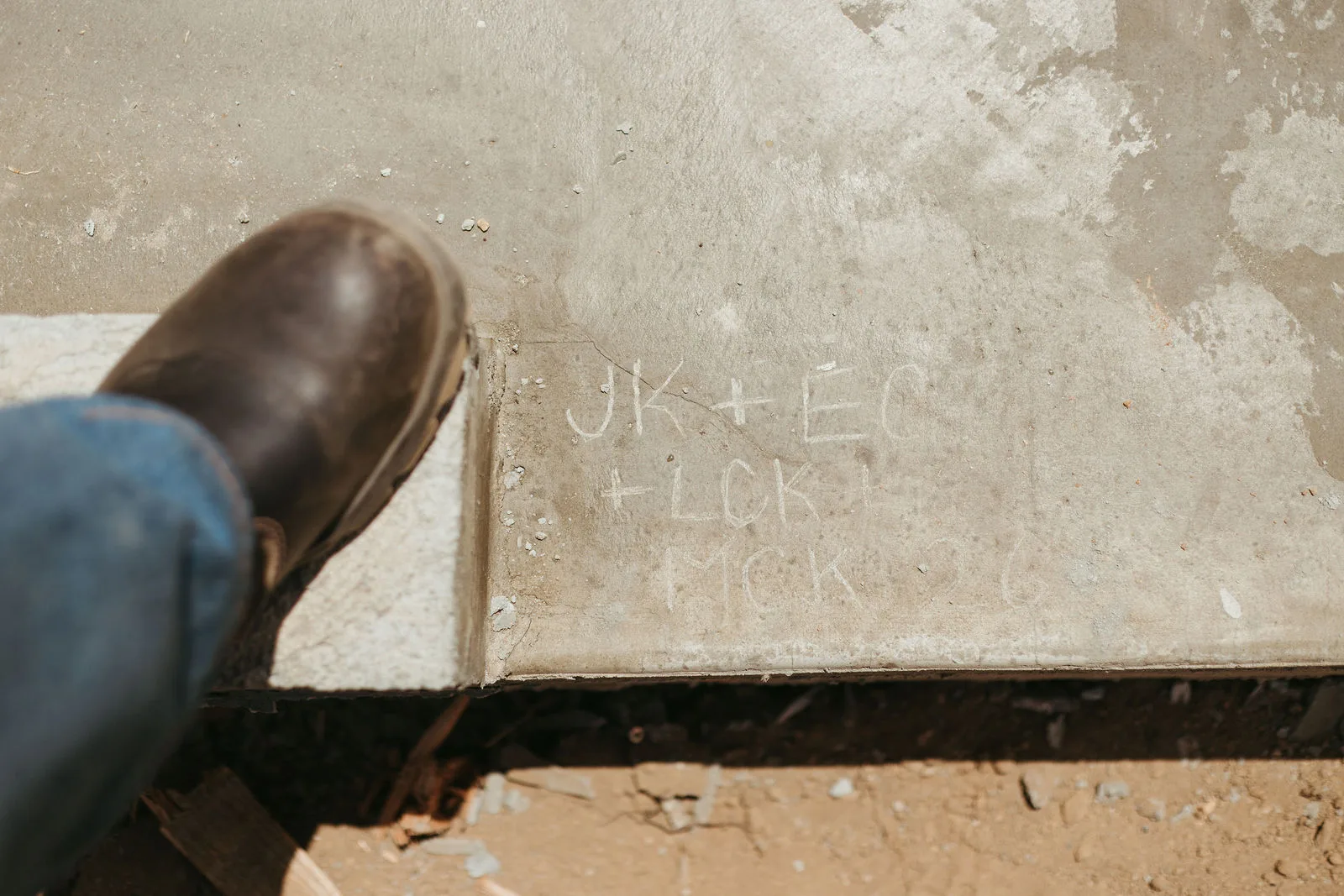 A family's initials written into fresh foundation concrete