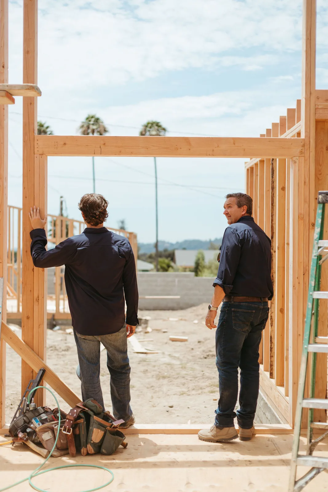 Paul and Simon in the framed doorway of an Altadena rebuild
