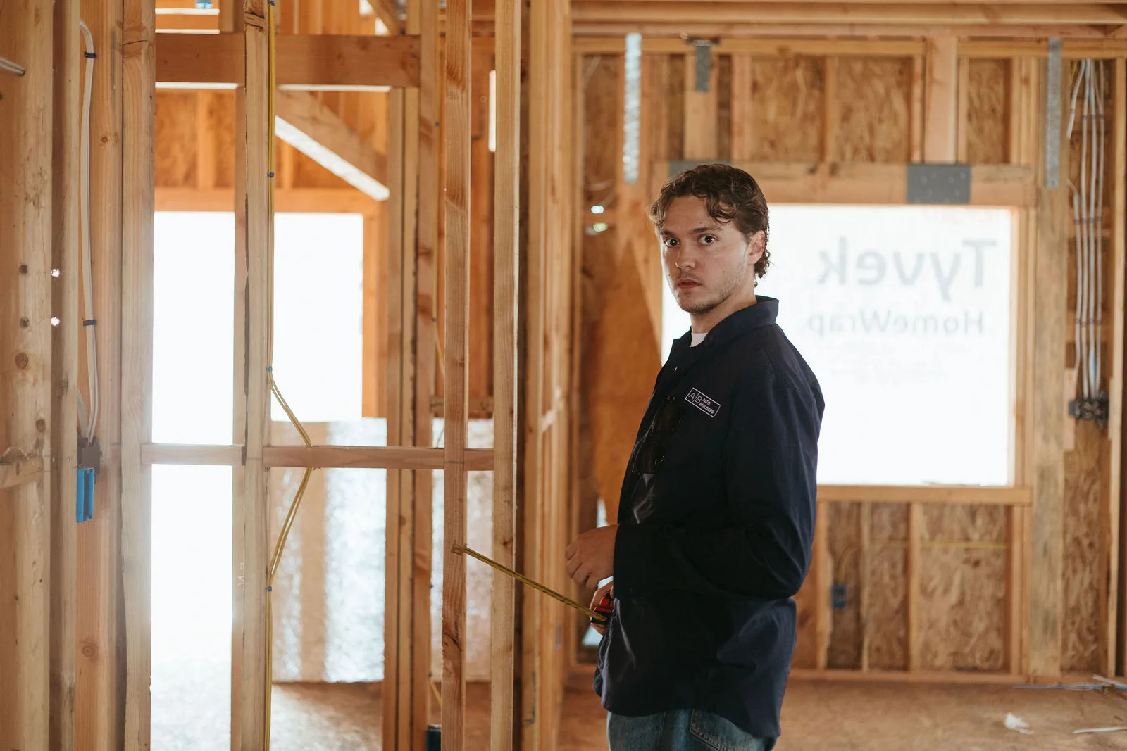 Simon inspecting framing on a new build