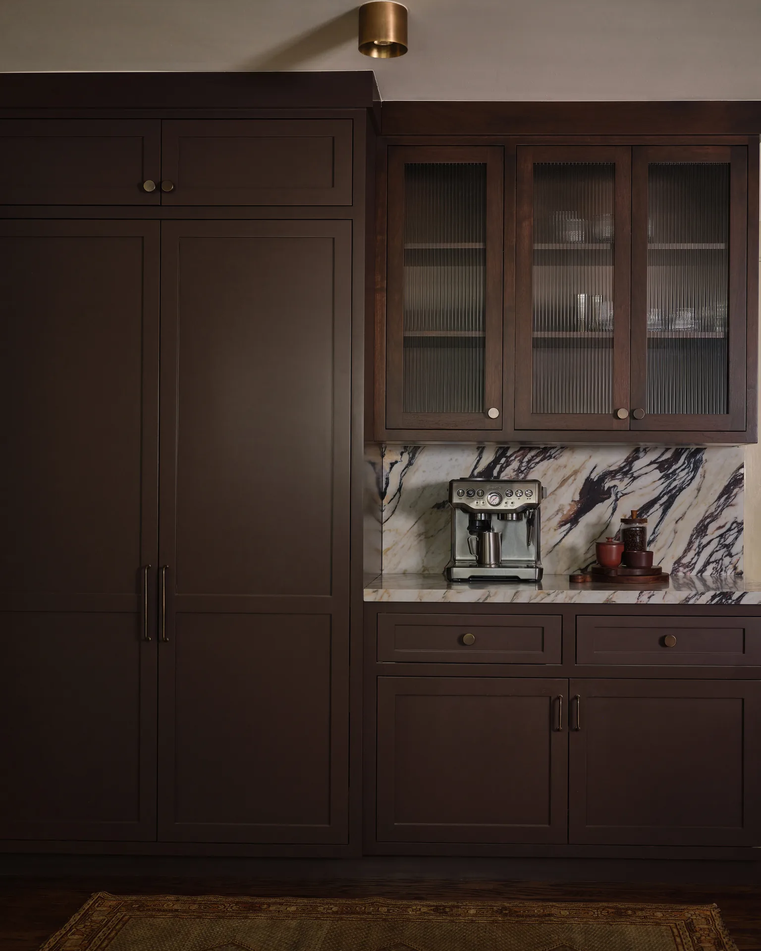 Full-height pantry cabinets and coffee station with marble backsplash